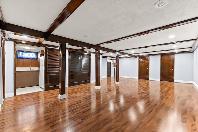 154-70 11th Ave, Beechhurst, NY 11357 - unfurnished living room with beam ceiling, wood finished floors, recessed lighting, ornate columns, and a textured ceiling