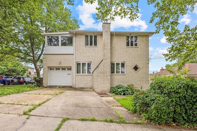 154-70 11th Ave, Beechhurst, NY 11357 - view of front of house featuring a chimney, driveway, an attached garage, and brick siding