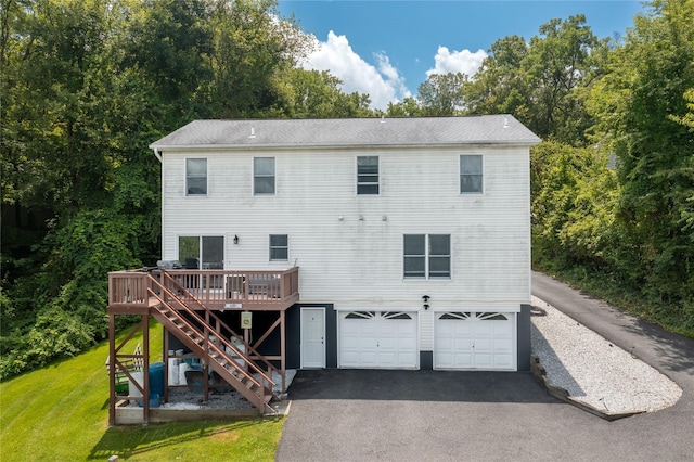 7 Glen Ct, Pawling, NY 12564 - rear view of property featuring an attached garage, stairs, driveway, a deck, and a lawn