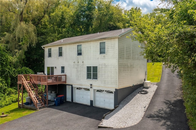 7 Glen Ct, Pawling, NY 12564 - rear view of property with a garage, stairs, driveway, and a deck