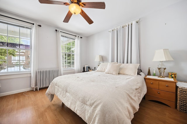 1639 Hone Ave, Bronx, NY 10461 - bedroom featuring radiator, wood finished floors, and ceiling fan
