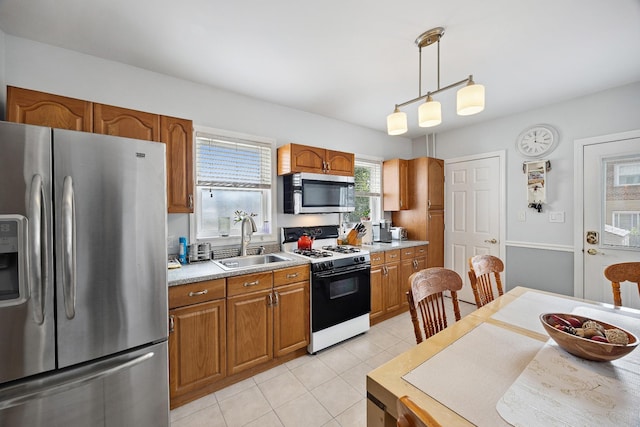 1639 Hone Ave, Bronx, NY 10461 - kitchen featuring stainless steel appliances, brown cabinets, light countertops, and decorative light fixtures