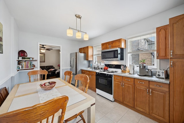 1639 Hone Ave, Bronx, NY 10461 - kitchen with stainless steel appliances, brown cabinets, decorative light fixtures, ceiling fan, and light countertops