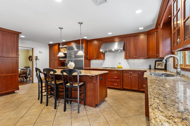 42 E Webster St, Merrick, NY 11566 - kitchen featuring appliances with stainless steel finishes, wall chimney range hood, light tile patterned floors, recessed lighting, and light stone countertops