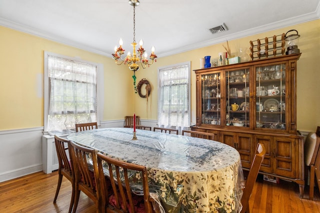 42 E Webster St, Merrick, NY 11566 - dining area with a chandelier, crown molding, and dark wood-style floors