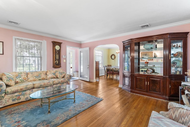 42 E Webster St, Merrick, NY 11566 - living room with arched walkways, wood finished floors, and crown molding
