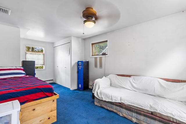 42 E Webster St, Merrick, NY 11566 - carpeted bedroom with multiple windows, a closet, a baseboard heating unit, and ceiling fan