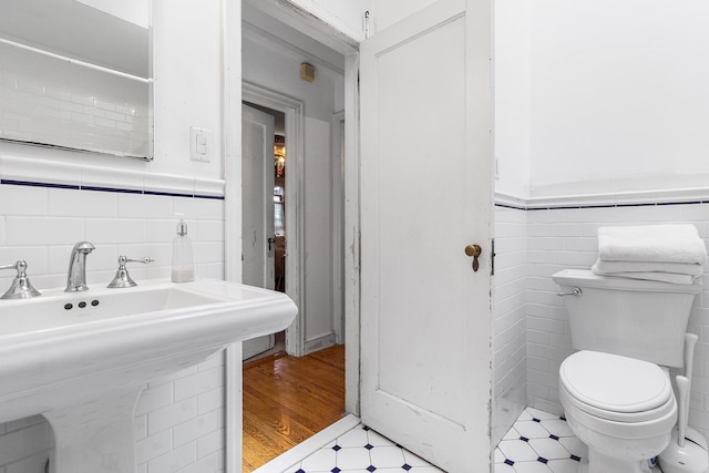 42 E Webster St, Merrick, NY 11566 - bathroom with tile walls, tile patterned floors, and a wainscoted wall