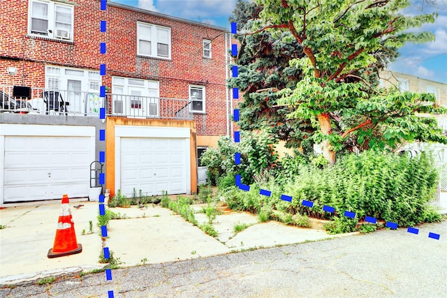 7914 Elks Rd, Elmhurst, NY 11373 - view of front facade featuring a garage and brick siding