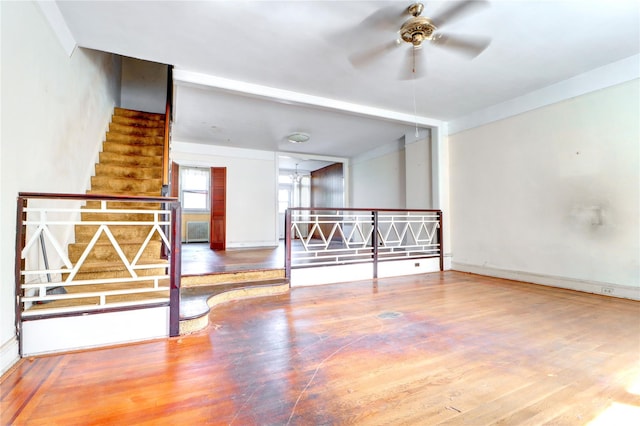 7914 Elks Rd, Elmhurst, NY 11373 - spare room featuring stairway, ceiling fan, radiator, and wood finished floors