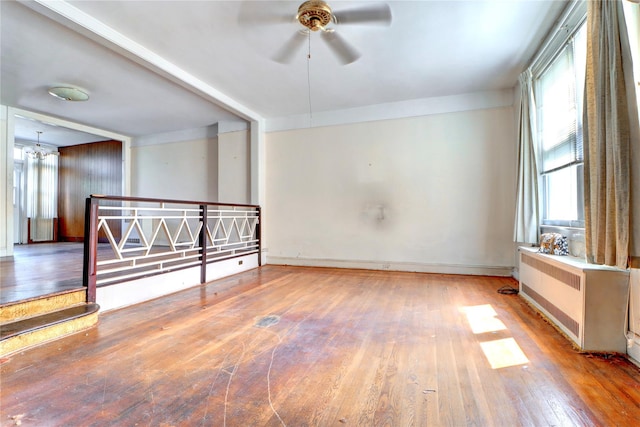 7914 Elks Rd, Elmhurst, NY 11373 - unfurnished room with radiator heating unit, wood-type flooring, and ceiling fan