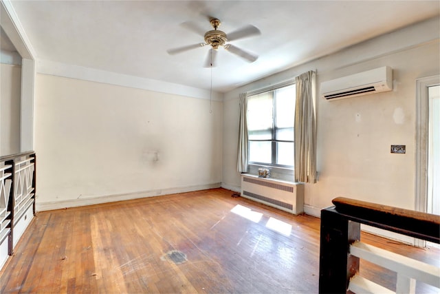 7914 Elks Rd, Elmhurst, NY 11373 - unfurnished living room featuring a wall unit AC, radiator, ceiling fan, and wood finished floors