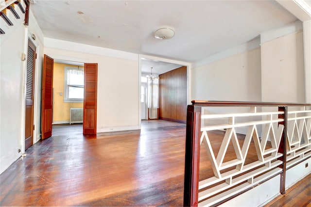 7914 Elks Rd, Elmhurst, NY 11373 - unfurnished room with radiator heating unit, wood finished floors, and a chandelier