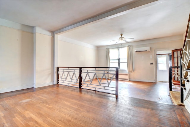 7914 Elks Rd, Elmhurst, NY 11373 - spare room with a wall mounted air conditioner, wood finished floors, ceiling fan, and baseboard heating
