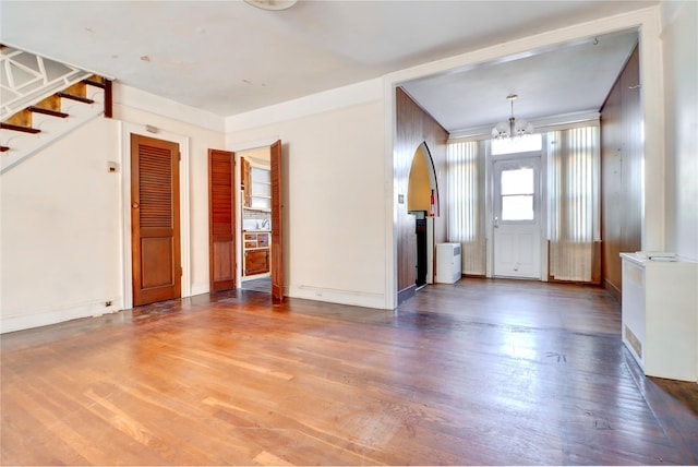 7914 Elks Rd, Elmhurst, NY 11373 - unfurnished living room featuring a chandelier, wood finished floors, and stairs