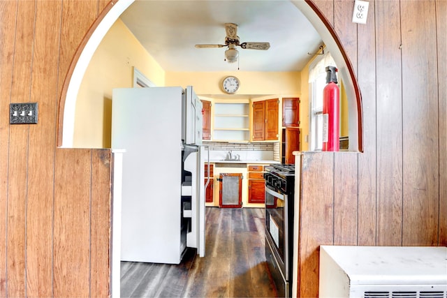 7914 Elks Rd, Elmhurst, NY 11373 - kitchen featuring freestanding refrigerator, gas range, a ceiling fan, dark wood-style floors, and backsplash