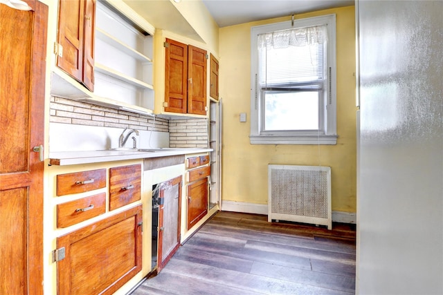 7914 Elks Rd, Elmhurst, NY 11373 - kitchen featuring radiator heating unit, dark wood-style floors, tasteful backsplash, light countertops, and brown cabinetry