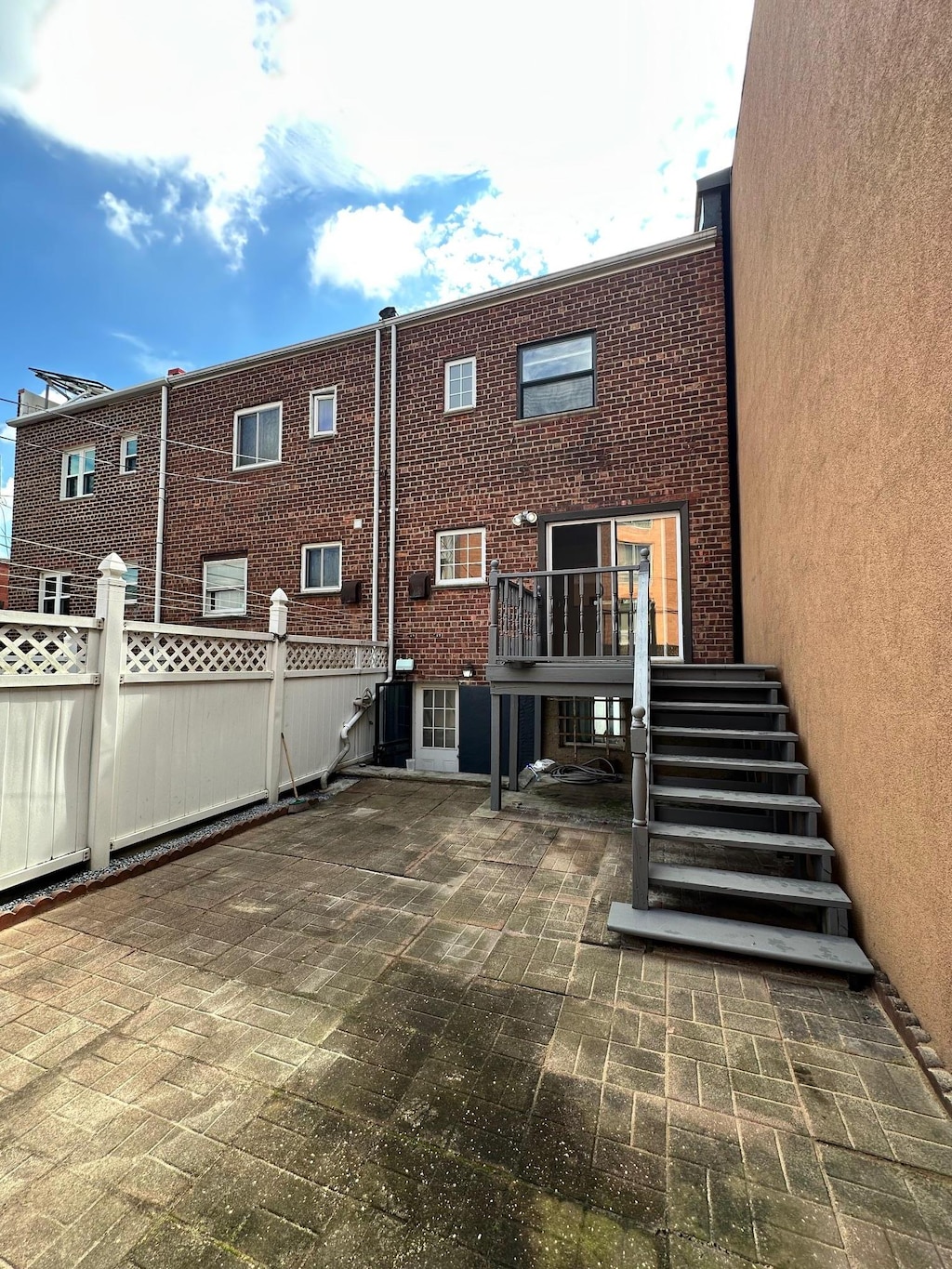 53-26 61st St, Maspeth, NY 11378 - rear view of property featuring stairway, a patio area, and brick siding