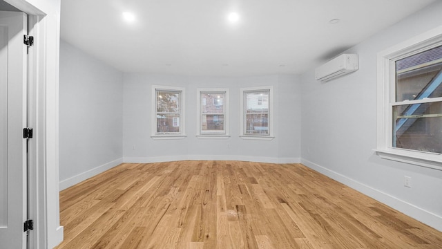 3919 Murdock Ave, Bronx, NY 10466 - unfurnished room with an AC wall unit and light wood-style floors