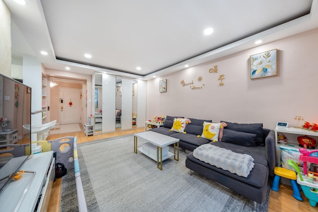140-10 84th Dr Unit 2B, Briarwood, NY 11435 - living area with recessed lighting, light wood finished floors, and a tray ceiling