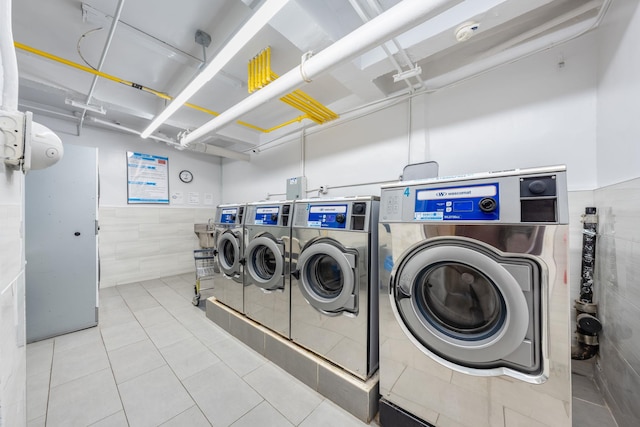 140-10 84th Dr Unit 2B, Briarwood, NY 11435 - community laundry with independent washer and dryer, tile walls, and tile patterned flooring