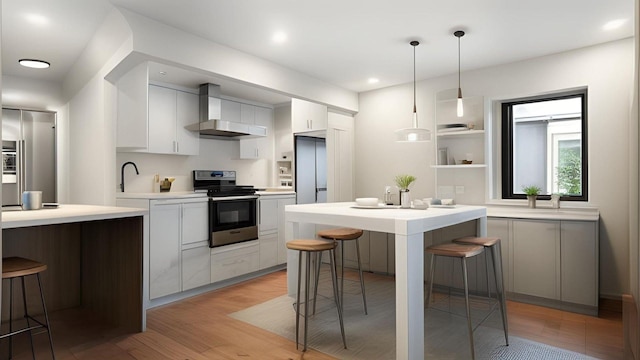 506 Van Nest, Bronx, NY 10460 - kitchen with stainless steel stove, wall chimney range hood, a kitchen bar, light countertops, and recessed lighting