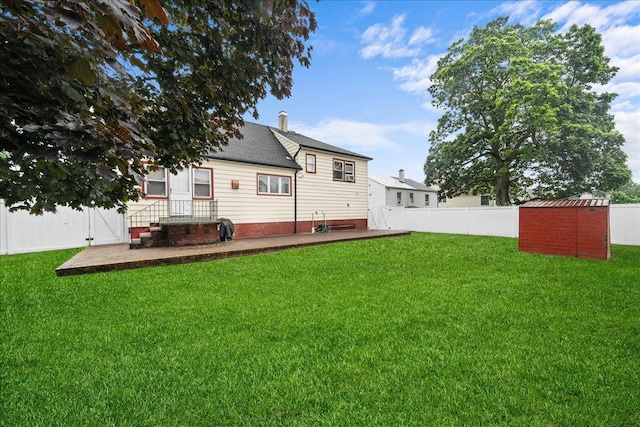 159 Branch Ave, Freeport, NY 11520 - back of property featuring a fenced backyard, a storage shed, and roof with shingles