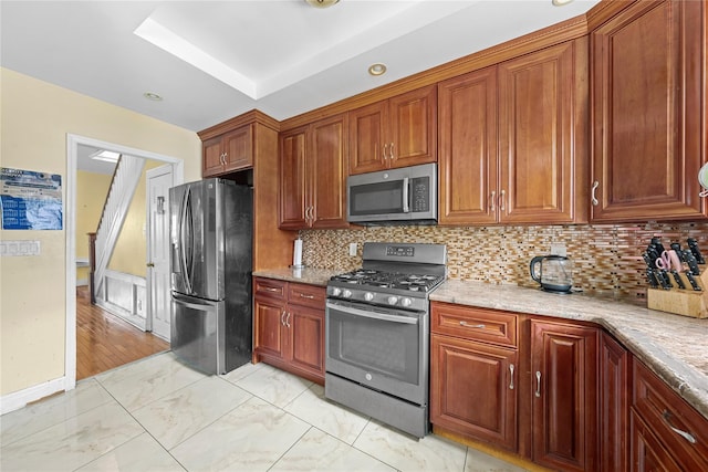 966 E 42nd St, Brooklyn, NY 11210 - kitchen featuring stainless steel appliances, tasteful backsplash, light marble finish floors, and brown cabinetry