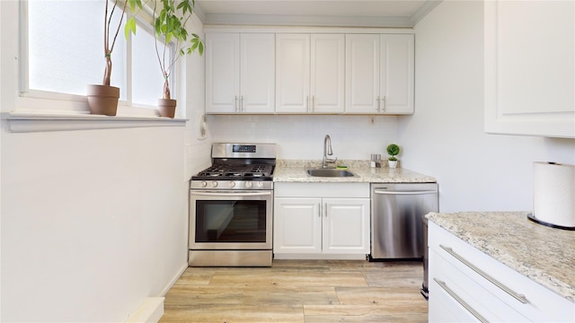 45 Tamarack St, Central Islip, NY 11722 - kitchen featuring stainless steel appliances, white cabinetry, and light wood-style flooring