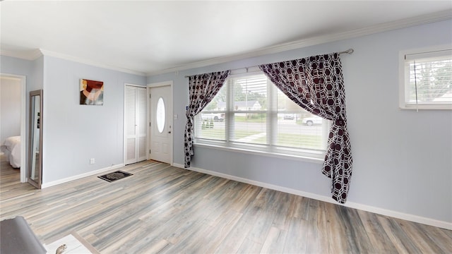 45 Tamarack St, Central Islip, NY 11722 - entrance foyer with light wood-type flooring, plenty of natural light, and ornamental molding