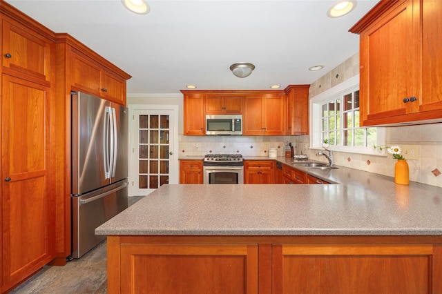 844 Salt Point Tpke, Pleasant Valley, NY 12601 - kitchen with appliances with stainless steel finishes, a peninsula, decorative backsplash, brown cabinets, and recessed lighting
