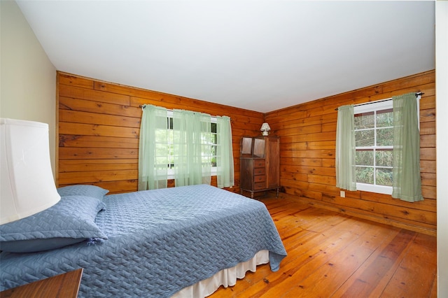 844 Salt Point Tpke, Pleasant Valley, NY 12601 - bedroom featuring multiple windows, wood walls, and hardwood / wood-style flooring