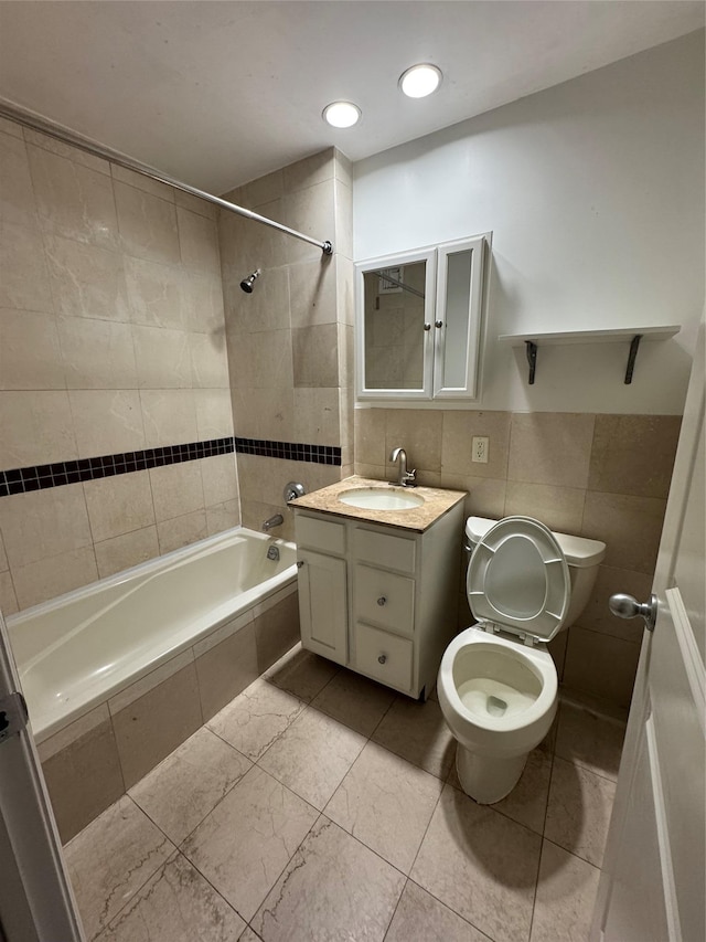 143-41 84th Dr Unit 1A, Briarwood, NY 11435 - bathroom featuring tile walls, tiled shower / bath combo, and vanity
