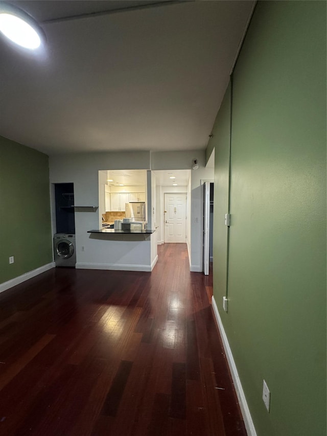 143-41 84th Dr Unit 1A, Briarwood, NY 11435 - unfurnished living room featuring washer / dryer and dark wood finished floors