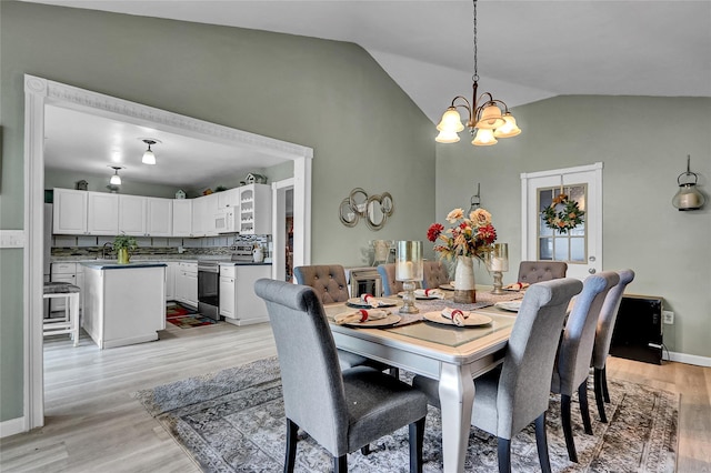 33 Breston Dr W, Shirley, NY 11967 - dining area with a chandelier, vaulted ceiling, and light wood-style floors