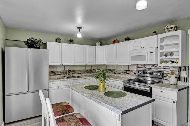 33 Breston Dr W, Shirley, NY 11967 - kitchen with appliances with stainless steel finishes, white cabinets, decorative backsplash, open shelves, and a center island