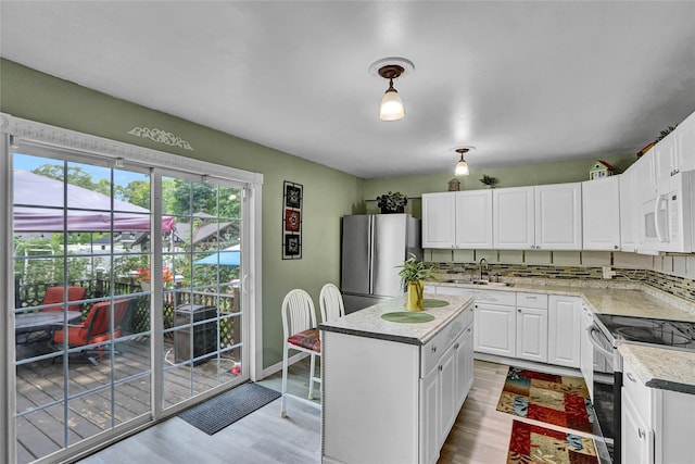 33 Breston Dr W, Shirley, NY 11967 - kitchen with stainless steel appliances, light wood finished floors, light countertops, and white cabinets