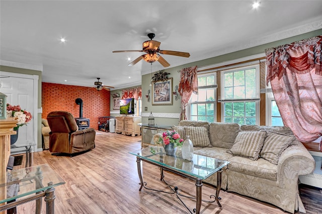 33 Breston Dr W, Shirley, NY 11967 - living room featuring a wood stove, a ceiling fan, recessed lighting, light wood-style flooring, and brick wall