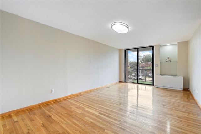 71-24 164th St Unit 2, Fresh Meadows, NY 11365 - spare room featuring wood finished floors and expansive windows