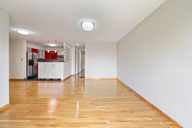 71-24 164th St Unit 2, Fresh Meadows, NY 11365 - unfurnished living room featuring baseboards and light wood finished floors