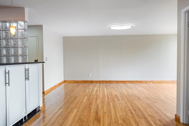 71-24 164th St Unit 2, Fresh Meadows, NY 11365 - unfurnished living room featuring light wood finished floors and baseboards