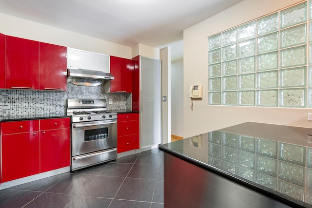 71-24 164th St Unit 2, Fresh Meadows, NY 11365 - kitchen featuring red cabinets, gas stove, ventilation hood, dark countertops, and backsplash
