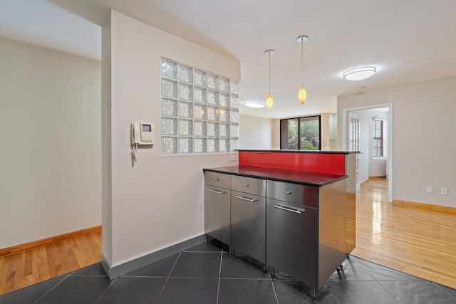 71-24 164th St Unit 2, Fresh Meadows, NY 11365 - kitchen featuring dark countertops, a peninsula, dark wood-style flooring, and decorative light fixtures