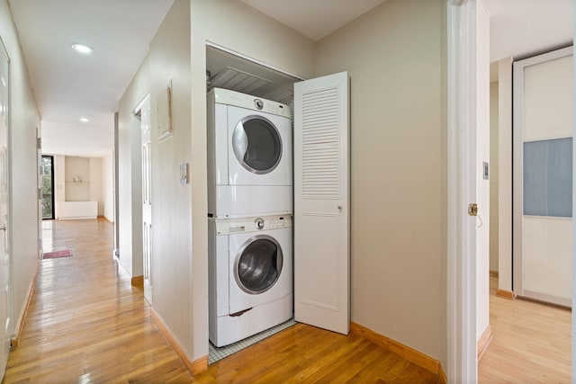 71-24 164th St Unit 2, Fresh Meadows, NY 11365 - laundry area with stacked washing machine and dryer, light wood-style flooring, and recessed lighting