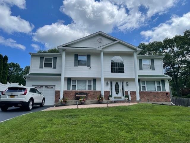 11 Dillmont Dr, Smithtown, NY 11787 - neoclassical / greek revival house with brick siding, a garage, a front lawn, and asphalt driveway