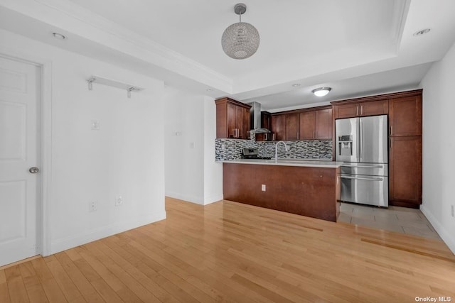 20-12 120th St, College Point, NY 11356 - kitchen featuring appliances with stainless steel finishes, wall chimney range hood, a raised ceiling, light countertops, and decorative backsplash