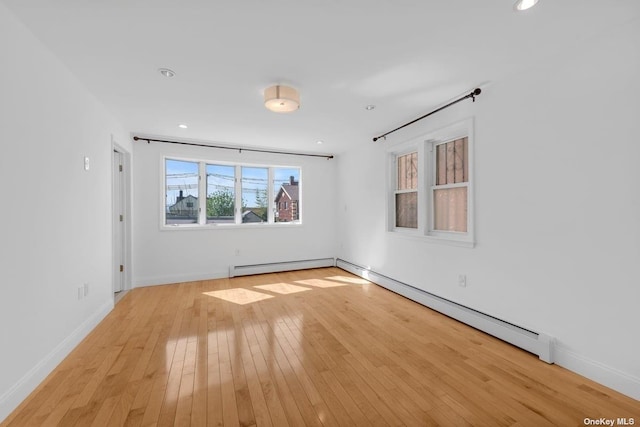 20-12 120th St, College Point, NY 11356 - unfurnished room featuring light wood-style floors, baseboard heating, and recessed lighting