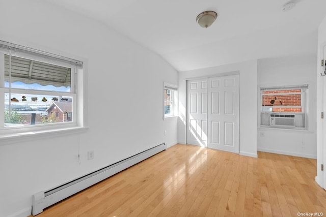 20-12 120th St, College Point, NY 11356 - unfurnished bedroom with baseboard heating, cooling unit, a closet, light wood finished floors, and lofted ceiling