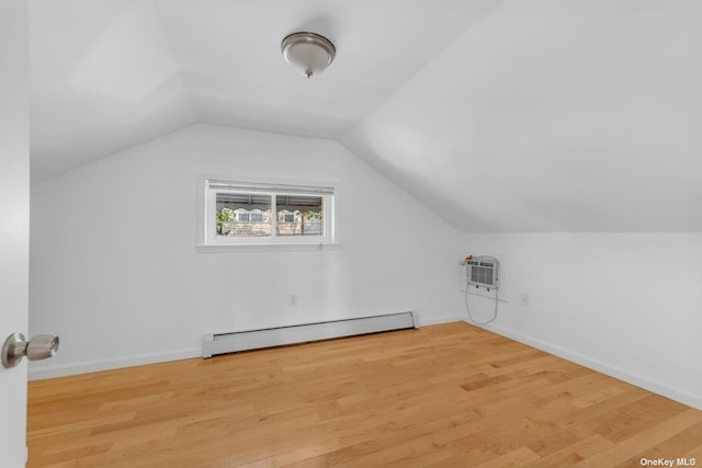 20-12 120th St, College Point, NY 11356 - bonus room with a baseboard heating unit, vaulted ceiling, wood finished floors, and a wall unit AC