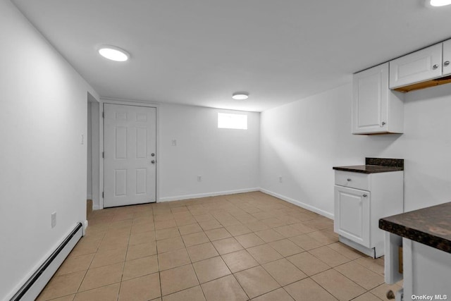 20-12 120th St, College Point, NY 11356 - below grade area with a baseboard radiator and light tile patterned floors